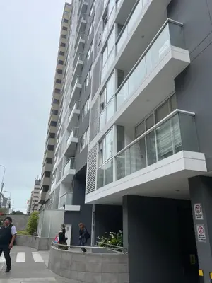 a tall building with people walking in front of it at Urbano Apartments Miraflores Pardo in Lima