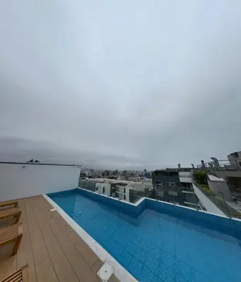 a swimming pool on the roof of a building at Urbano Apartments Miraflores Pardo in Lima
