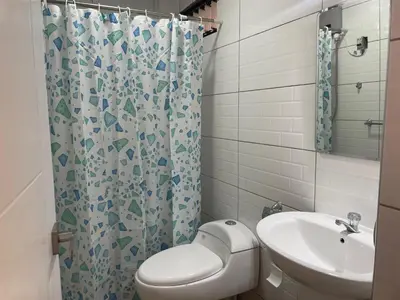 a bathroom with a toilet and a sink and a shower at La Casa del Valle - Huaripampa in Huaripampa