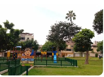 a playground in a park with a fence at Departamento Acogedor en Surco in Lima