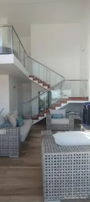 a living room with two beds and a staircase at Zen Home & Relax - Chincha in Chincha Baja
