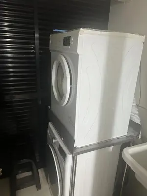 a washing machine sitting on top of a refrigerator at Luxury Aparment in San Isidro in Lima