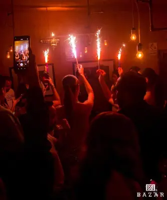 a crowd of people holding up sparklers at a party at Chelovirock- Luxury Penthouse Great Location in Lima