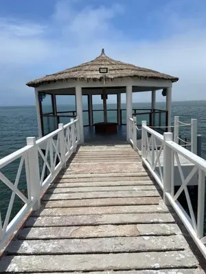 a pier with a gazebo on the water at Dpto en Paracas con vista al Mar in Paracas