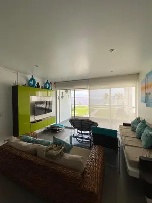 a living room with two couches and a table at Dpto en Paracas con vista al Mar in Paracas