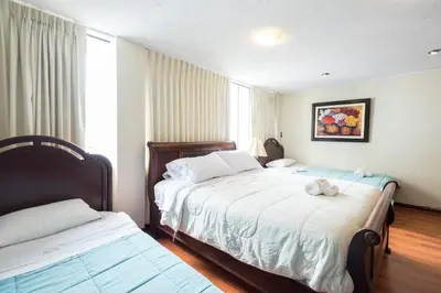a bedroom with two beds and a stuffed animal on the bed at INTI KILLA Hostel in Lima