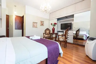 a hotel room with a bed and a dining room at INTI KILLA Hostel in Lima