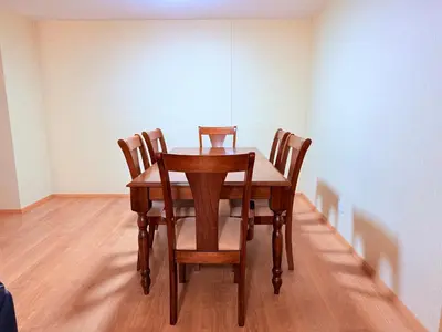 a wooden table with four chairs in a room at Acogedor Departamento en Lima in Lima