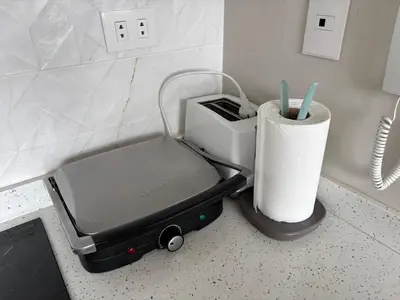 a piece of luggage sitting on a counter with toothbrushes at Dormitorio con baño en departamento Miraflores in Lima