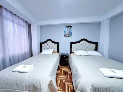 two beds sitting next to each other in a bedroom at Jerusalen Inn-Dep 4 in Cusco