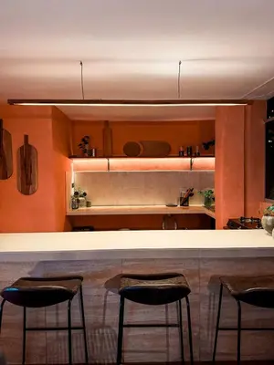 a kitchen with two bar stools at a counter at House Sacha 1BR Great View Huanuco in Huánuco