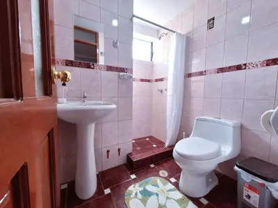a bathroom with a toilet and a sink at Jerusalen Inn -Dep 1 in Cusco