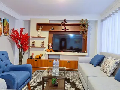 a living room with a couch and a tv at Jerusalen Inn -Dep 1 in Cusco