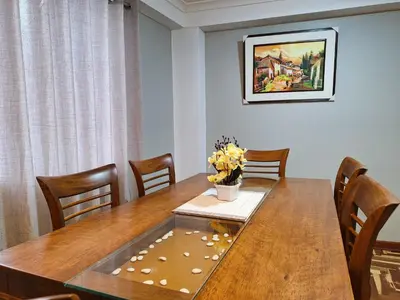 a dining room table with a vase of flowers on it at Jerusalen Inn -Dep 1 in Cusco