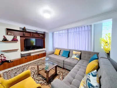 a living room with a couch and a tv at Jerusalen Inn-Dep 2 in Cusco