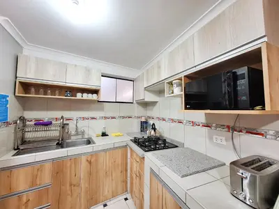 a kitchen with a sink and a stove at Jerusalen Inn-Dep 2 in Cusco