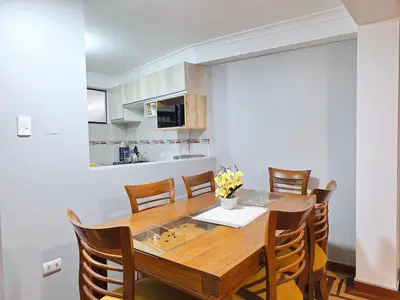 a kitchen and dining room with a wooden table and chairs at Jerusalen Inn-Dep 2 in Cusco