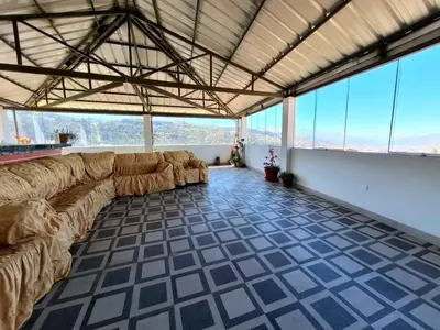 a large living room with couches in a room with windows at Jerusalen Inn-Dep 2 in Cusco