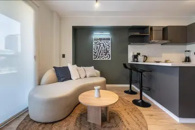 a living room with a couch and a table at Canaval y Moreyra by Geko in Lima