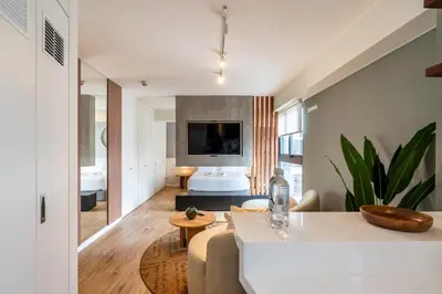 a living room with a couch and a tv at Canaval y Moreyra by Geko in Lima