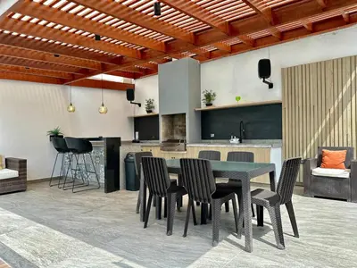 a dining room with a table and chairs at Casa de Playa en Pulpos Punta Hermosa in Lurín