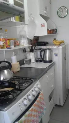 a kitchen with a stove top oven with pots and pans at Departamento 5p Lima Centro 3 dormitorios 4 camas in Lima