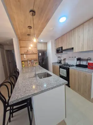 a kitchen with a sink and a counter top at Departamento a un paso de playa Pulpos y Arica in Lurín