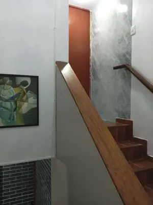 a staircase in a house with a painting on the wall at Departamento 2 HABITACIONES 1A in Lima