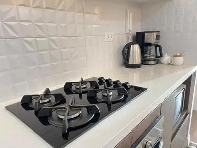 a kitchen with a black stove top in a kitchen at Design Apartment with city view! - Miraflores in Lima