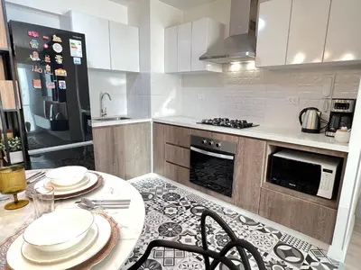 a kitchen with a table with plates on it at Design Apartment with city view! - Miraflores in Lima