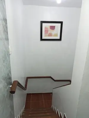 a stairway with a picture on the wall at Habitación 02 CAMAS 1C in Lima