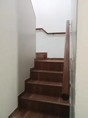 a stairway with wooden steps in a building at Habitación 02 CAMAS 1C in Lima