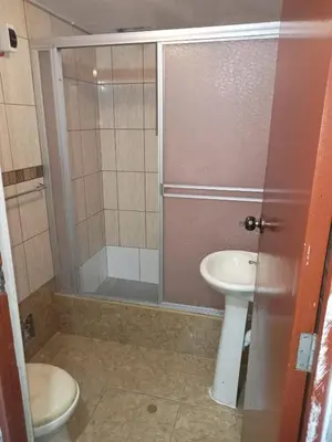 a bathroom with a shower and a toilet and a sink at Habitación 02 CAMAS 1C in Lima