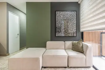 a living room with a couch and a painting at Gardenia by Geko in Lima