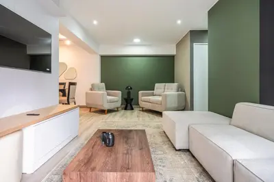 a living room with a couch and a table at Gardenia by Geko in Lima