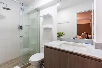 a bathroom with a toilet and a sink and a shower at Gardenia by Geko in Lima