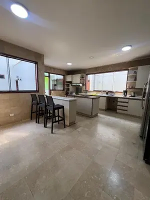 a large kitchen with four chairs and a counter at casa Alva in La Molina