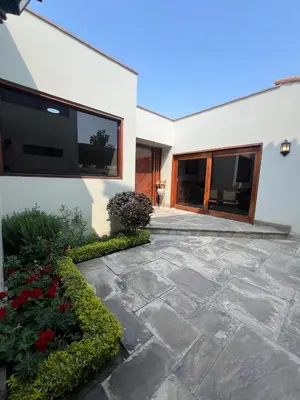 a house with a stone walkway next to a building at casa Alva in La Molina