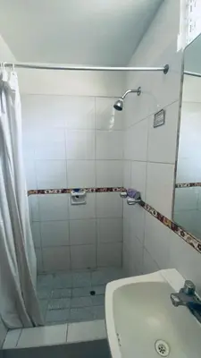 a bathroom with a shower and a tub and a sink at Lindo departamento en Miraflores Parque Kennedy in Lima