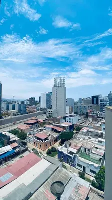 a view of a city with buildings and a blue sky at Lindo departamento en Miraflores Parque Kennedy in Lima