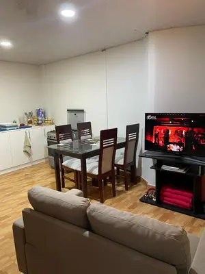 a living room with a couch and a table with a tv at Minidepartamento de 3 pisos, completo y comodo in Cusco
