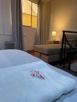 a bedroom with a bed with a white blanket at Minidepartamento de 3 pisos, completo y comodo in Cusco