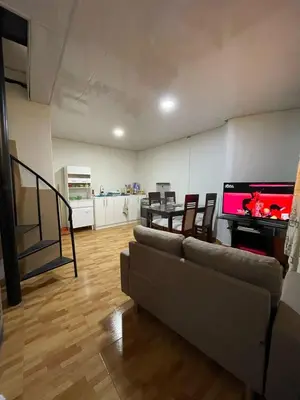 a living room with a couch and a flat screen tv at Minidepartamento de 3 pisos, completo y comodo in Cusco
