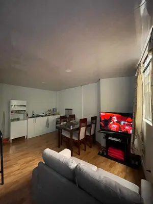 a living room with a couch and a table with a television at Minidepartamento de 3 pisos, completo y comodo in Cusco
