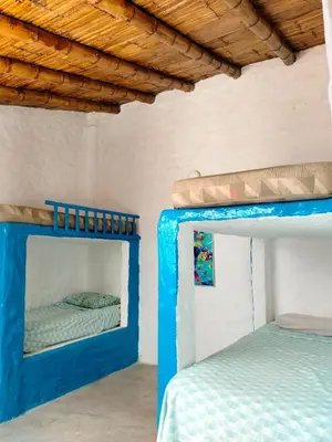 two bunk beds in a room with a ceiling at Casa bonita en Playa Los Lobos in Cerro Azul