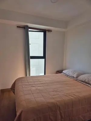 a bedroom with a large bed and a window at Apartamento Mary in Lima
