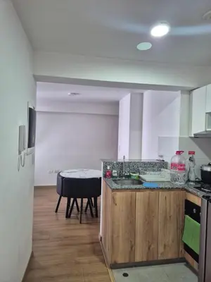 a kitchen with a counter and a table in it at Apartamento Mary in Lima