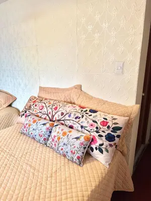 a bed with two pillows on top of it at Cuzco Lodgement in Lima
