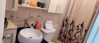 a small bathroom with a toilet and a sink at Confort Maruja in Lima