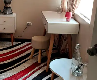 a room with a desk and a chair and a table at Confort Maruja in Lima